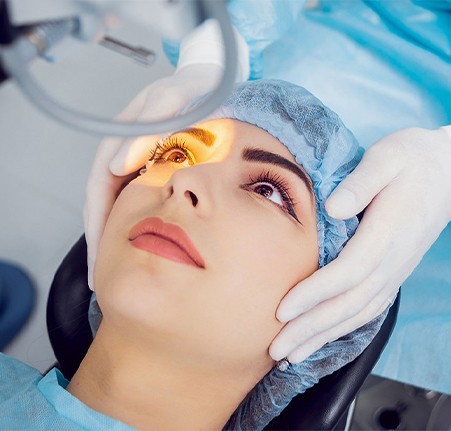 A woman receiving refractive surgery treatment.