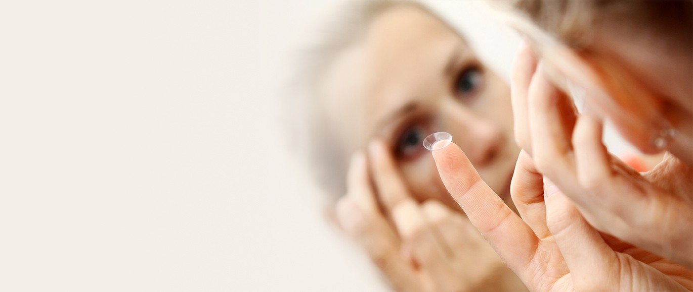 Woman putting on new contact lenses Prescribed to her by Bristol