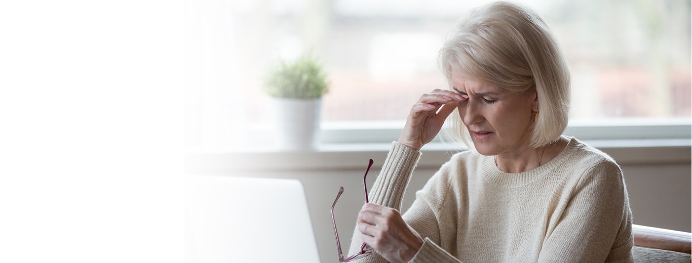 Elderly woman suffering from dry eye