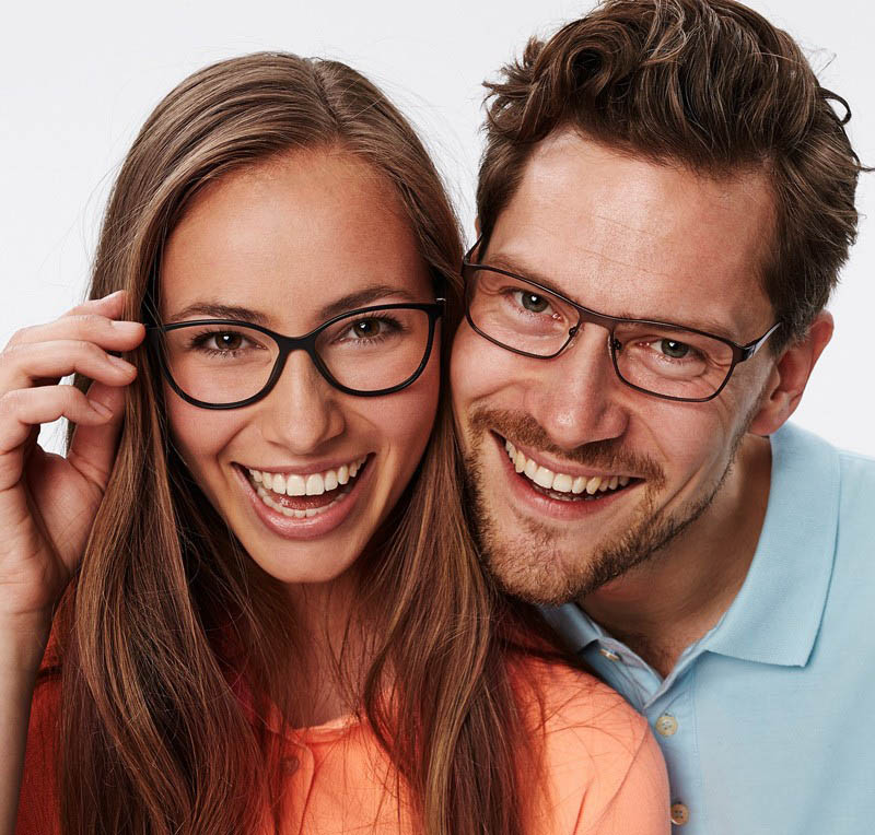 Smiling man and woman wearing glasses