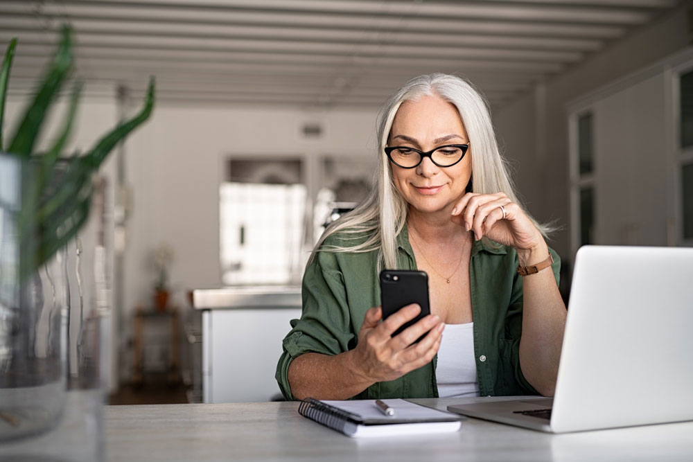 blonde woman wearing her reading glasses